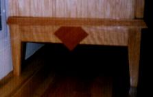 Detail on the side of my china cabinet. The case itself and the shelves were made of red oak veneer plywood, with solid oak edging. The base and top molding were solid red oak. Accents made from mahogany. 