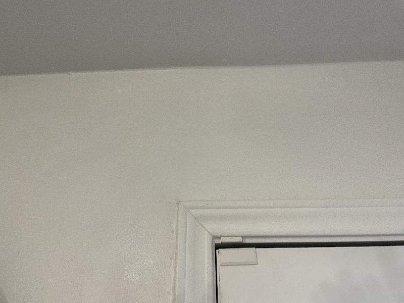 Closeup showing an invisible drywall crack repair. 