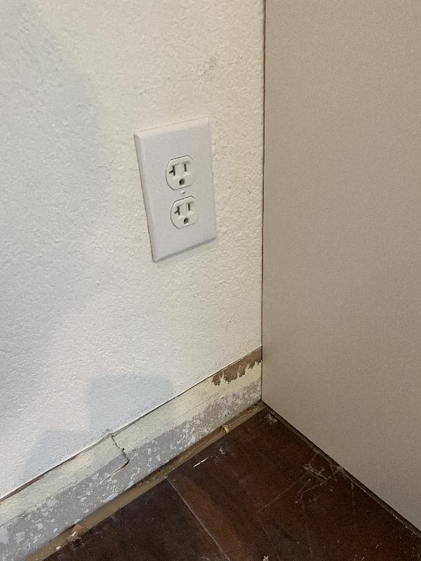 Asked the client what to do about this outlet. They decided to just cut a hole in the cabinet in case they needed to access it.  