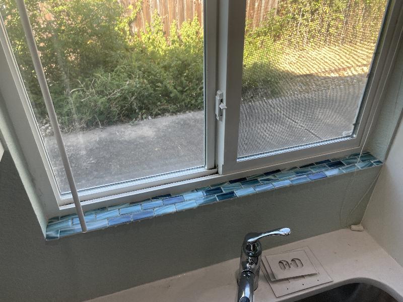 Windowsill tiles laid out ready to install 